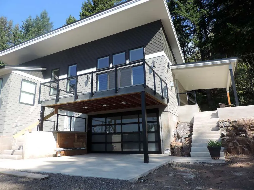 Shed-roof contemporary home with a cable-rail deck on a sloping lot