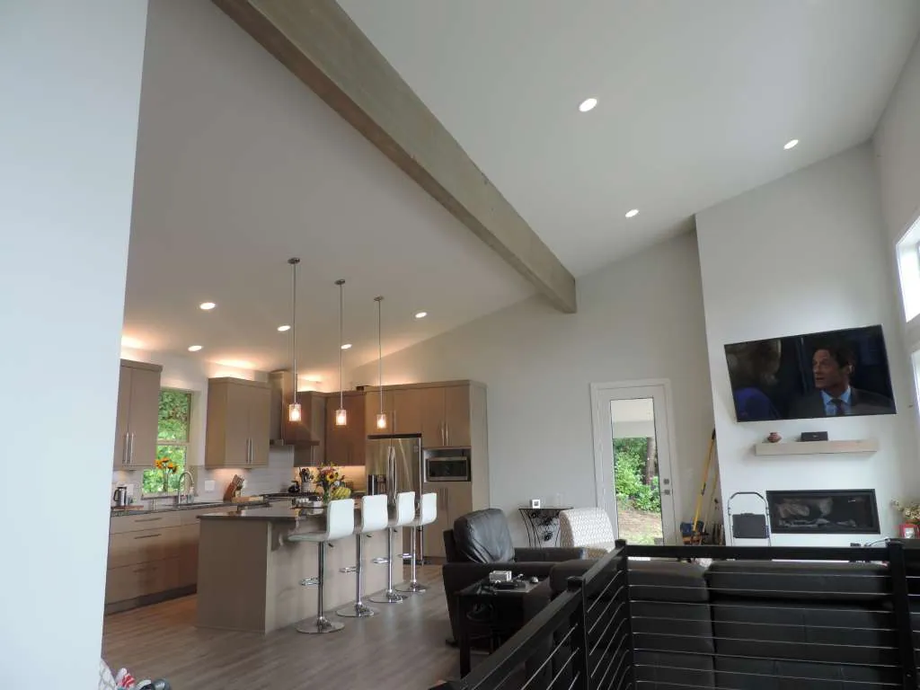 Vaulted great room with a wood beam and kitchen island