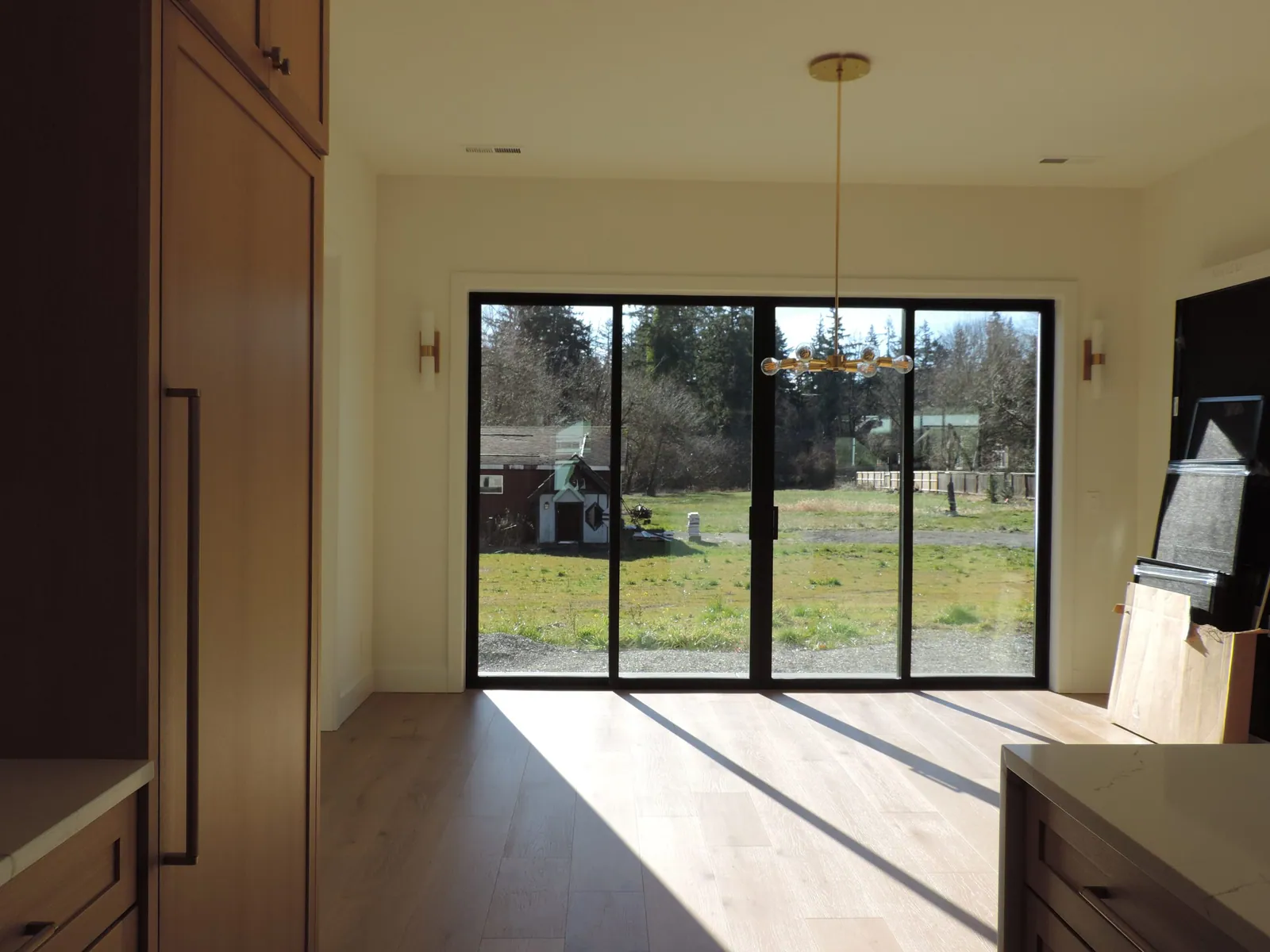 Dining area with black sliding doors opening to the yard