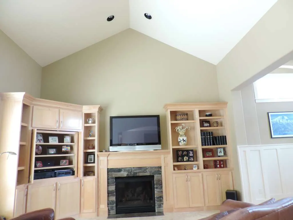 Maple media wall with a stone fireplace