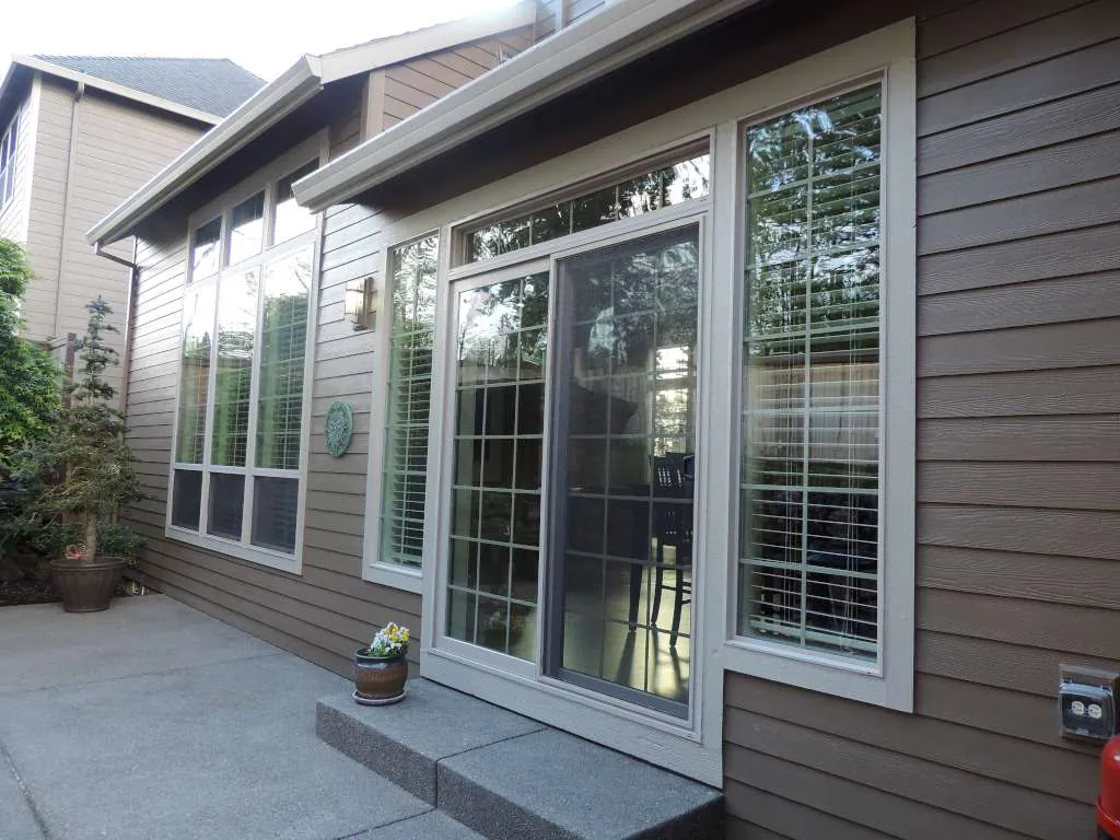 Rear patio with tall windows and sliding doors