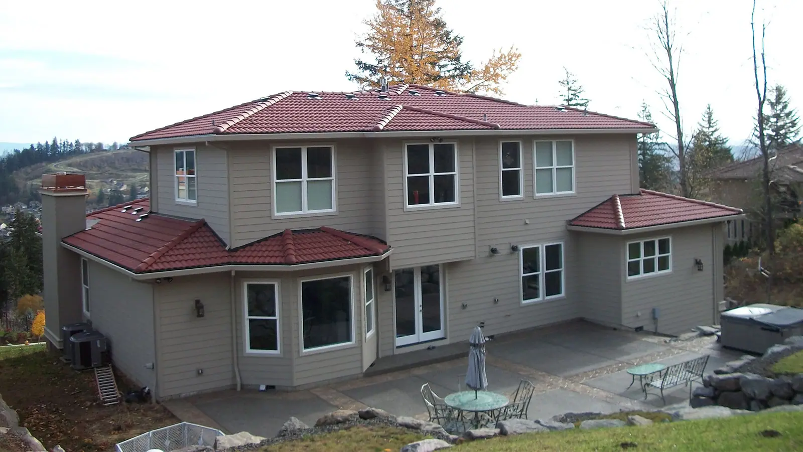 Two-story home with a red tile roof and a backyard patio