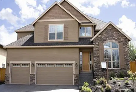 Two-story home with stone accents and three-car garage